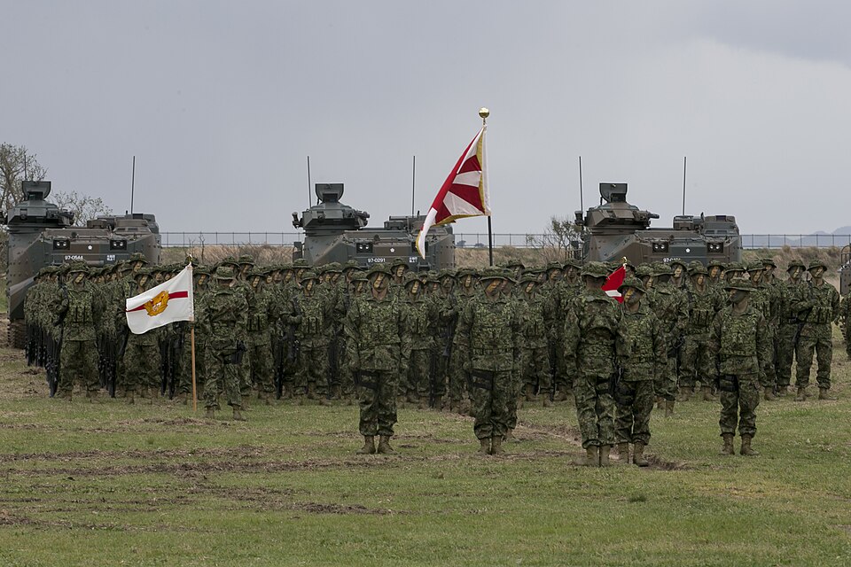 Service members with the Japan Ground Self-Defense Force stand in formation during the Japanese Amphibious Rapid Deployment Brigade’s unit-activation ceremony at Camp Ainoura, Japan, April 7, 2018. The 31st Marine Expeditionary Unit supported the ceremony with a fast rope demonstration from a CH-53E Super Stallion. As the Marine Corps’ only continuously forward-deployed MEU, the 31st MEU provides a flexible force ready to perform a wide range of military operations throughout the Indo-Pacific region. (U.S. Marine Corps photo by Lance Cpl. Amy Phan/Released)