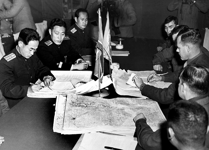 Col. James Murray, Jr., USMC, and Col. Chang Chun San, of the North Korean Communist Army, initial maps showing the north and south boundaries of the demarcation zone, during the Panmunjom cease fire talks.  October 11, 1951. F. Kazukaitis. (Navy)NARA FILE #:  080-G-437021WAR & CONFLICT BOOK #:  1516
